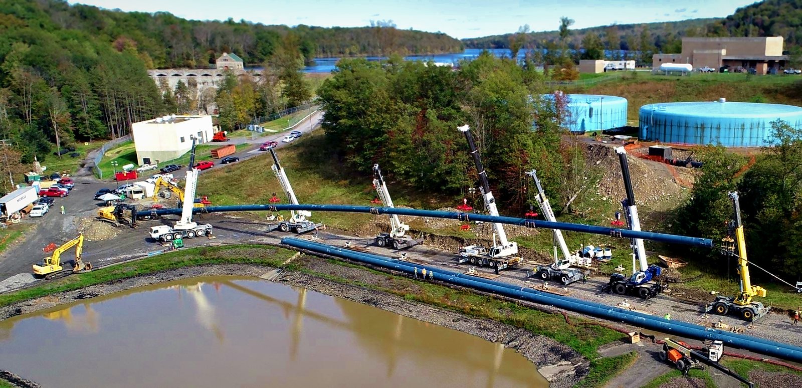 Pipe string held on cranes for HDD pullback