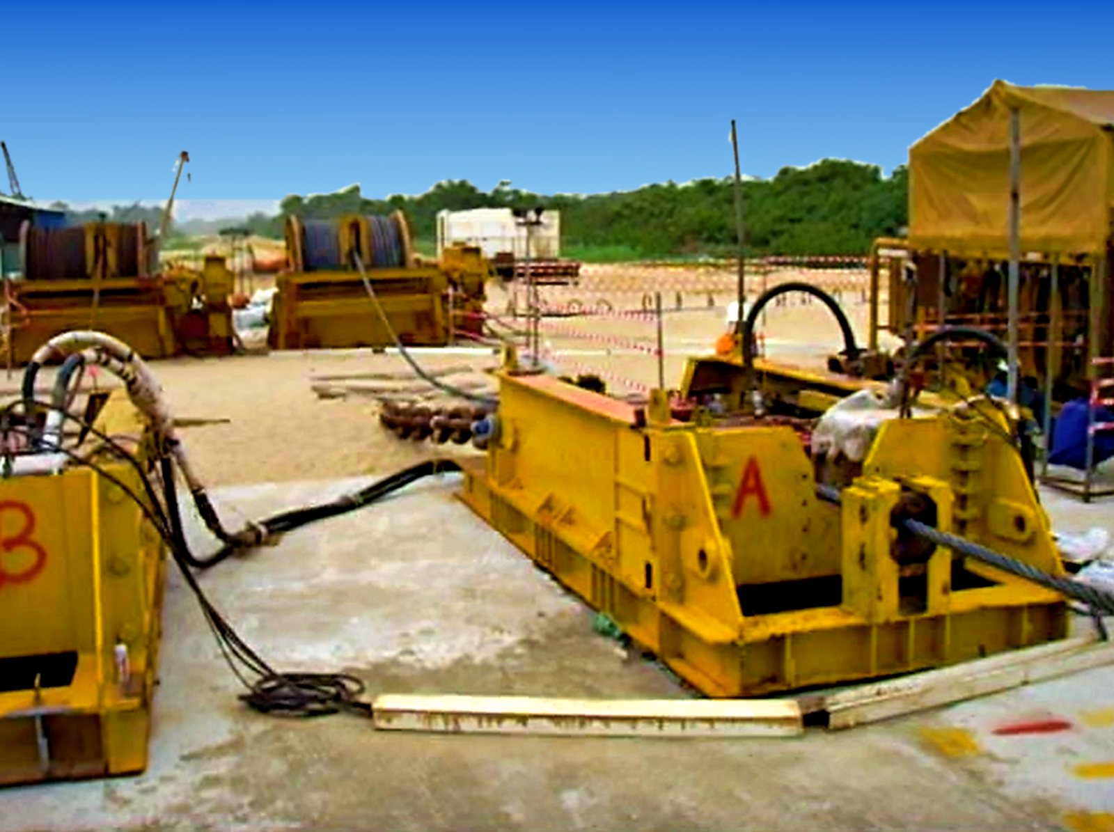 Linear (Lucker) pull-in winch A anchored on a concrete pad