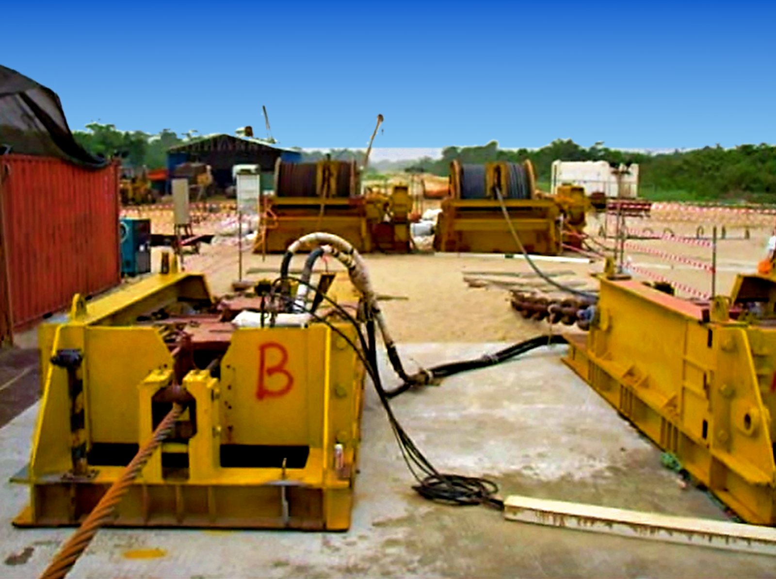 Linear winch yard with winches anchored on a concrete pad