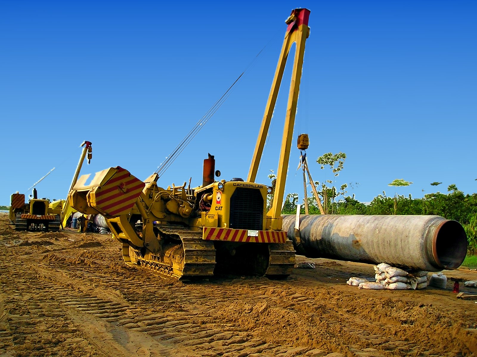Sideboom stringing a concrete-coated joint