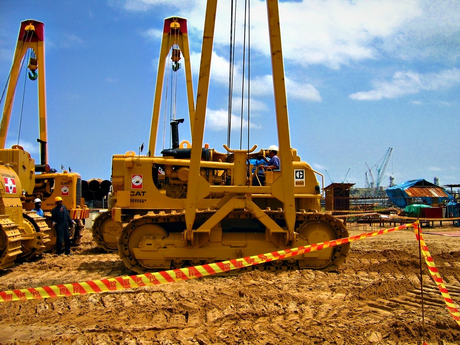 Sideboom pipelayers ready for mobilization in the equipment yard