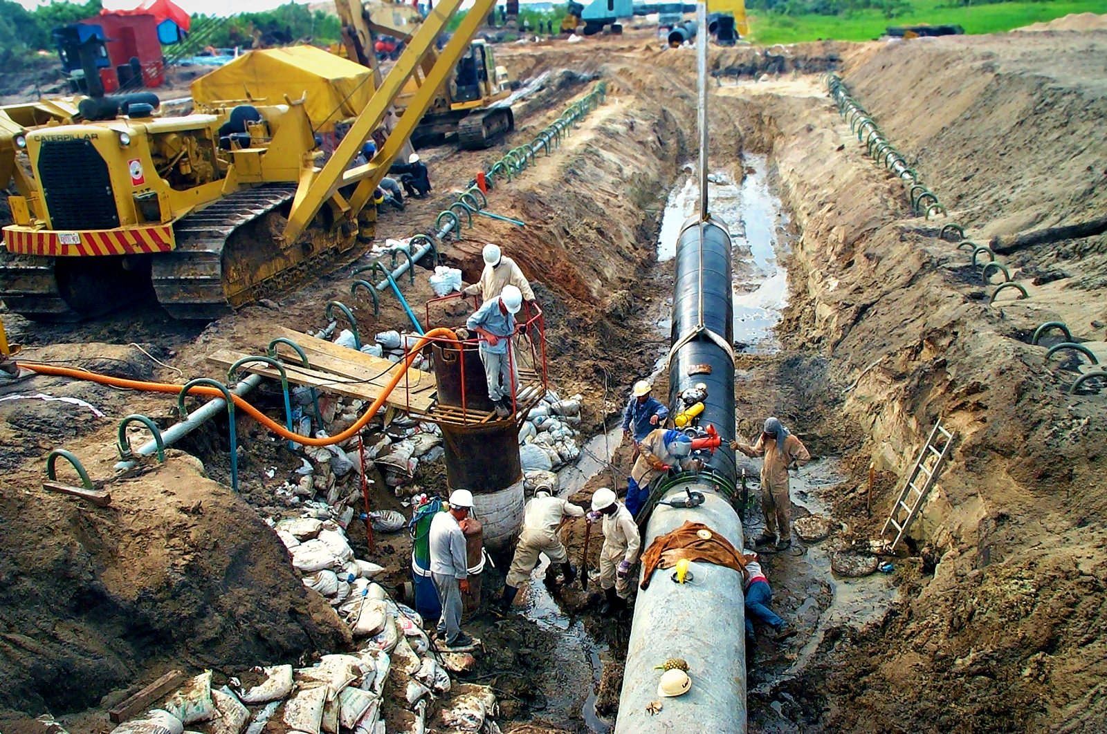 Crew completing a tie-in in a wet trench