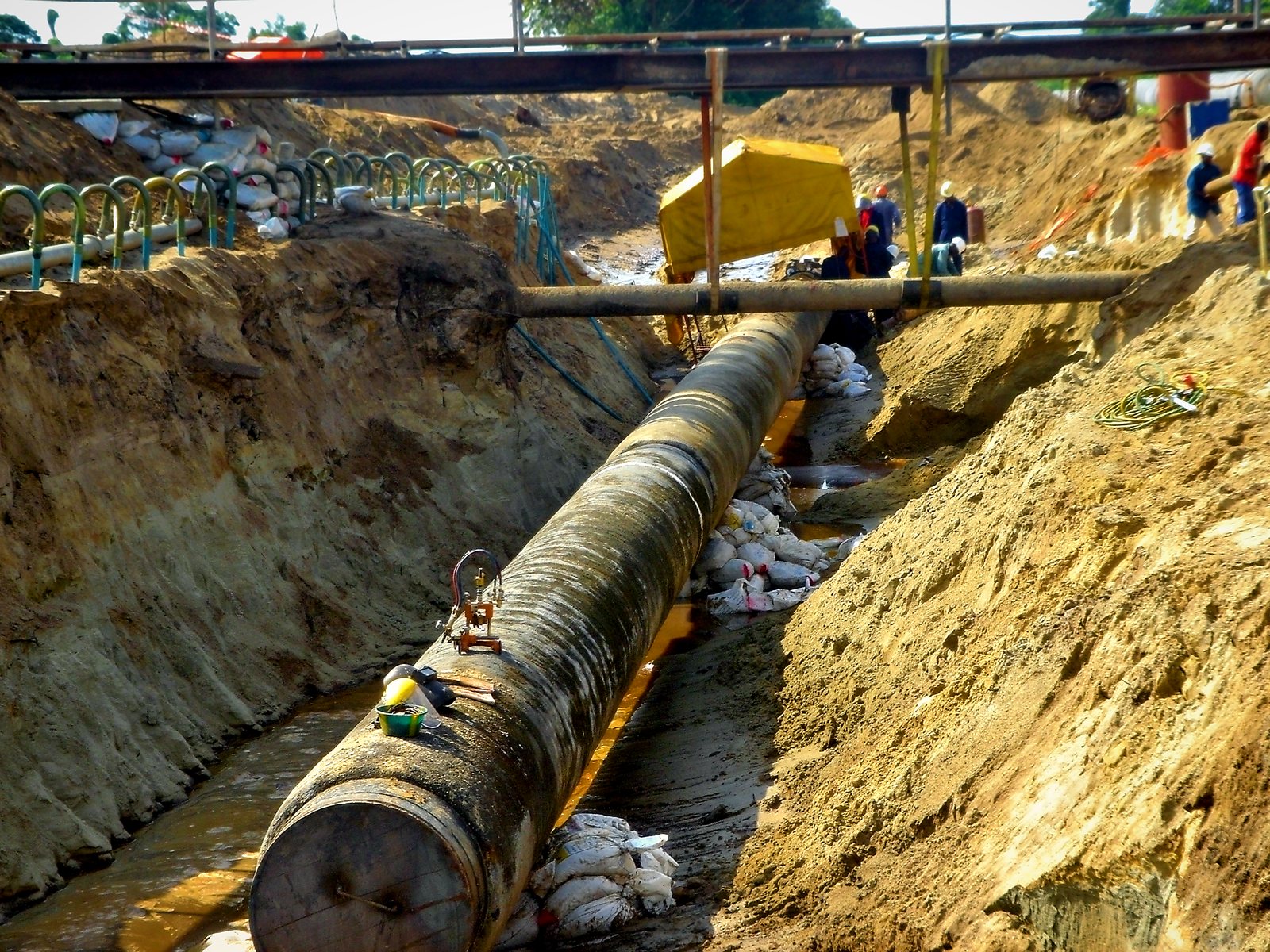 Pipe in a deep trench beneath a temporary bridge